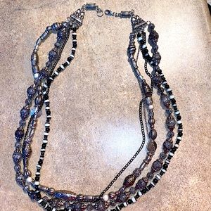 Five strand silver and black necklace.